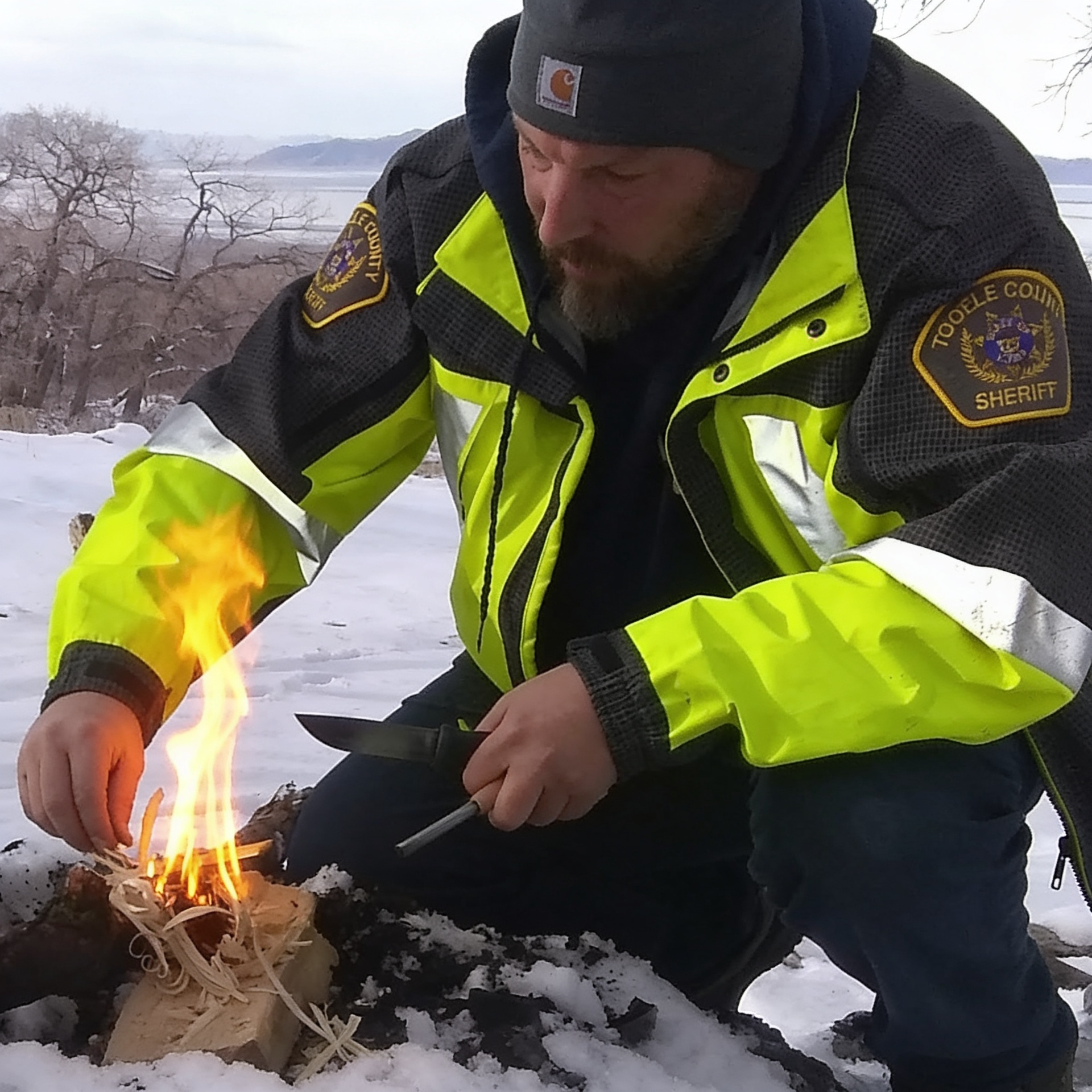 Lead instructor demonstrating fire starting during a winter SAR clinic